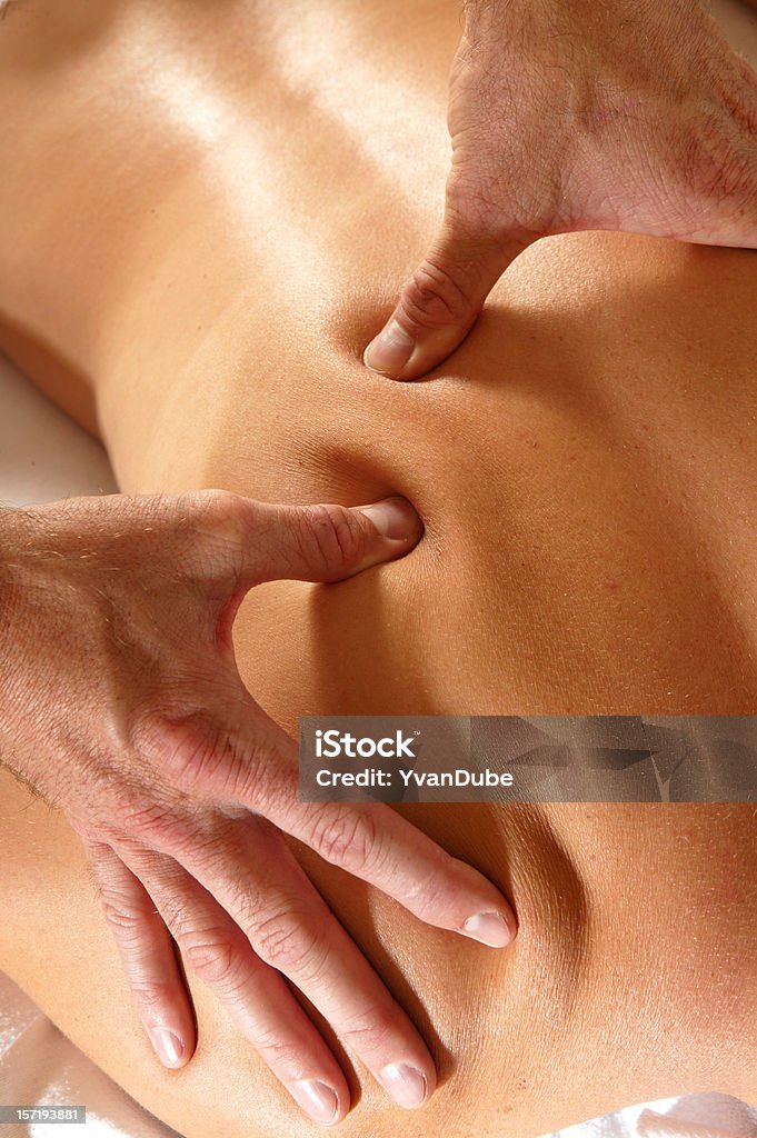 woman back getting a massage Close-up on a woman back getting a massage by a man Massaging Stock Photo