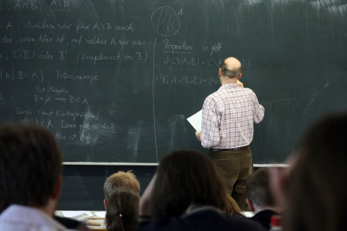 Professor writing on the blackboard.