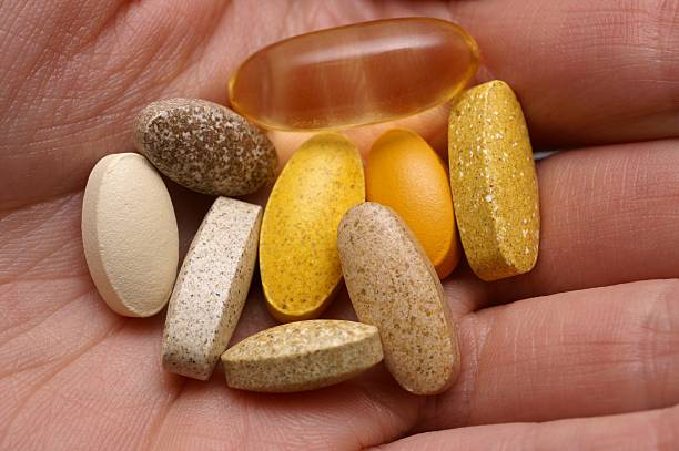 istock Close-up of nine medicine tablets in a person's hand 157194504