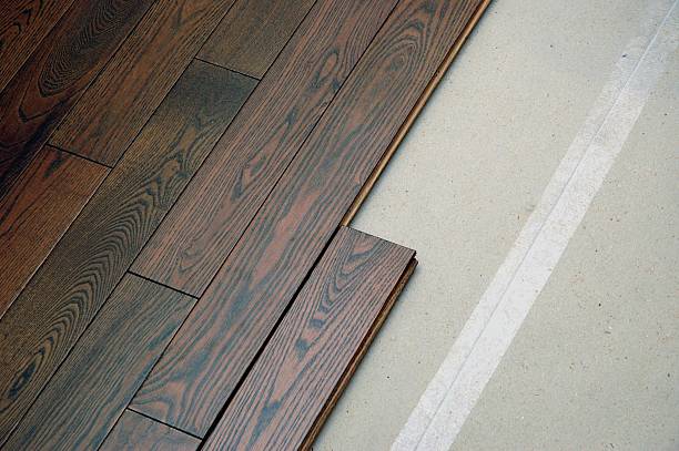 Hardwood floor in the installation process A hardwood floor installation in progress. wood laminate flooring photos stock pictures, royalty-free photos & images