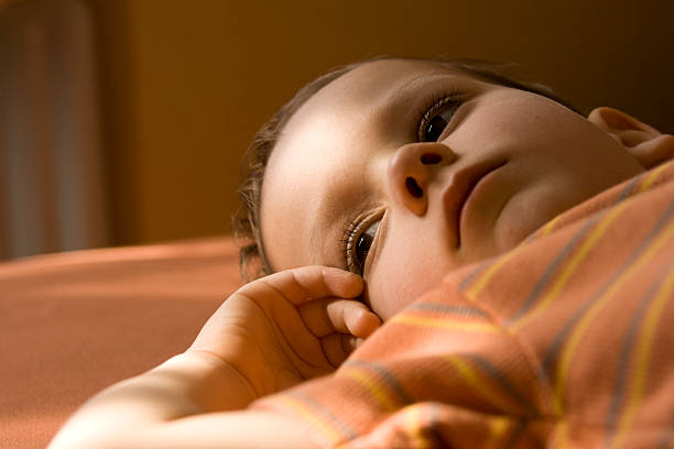 istock Close low angle image of a sad young boy with orange shirt 157194942