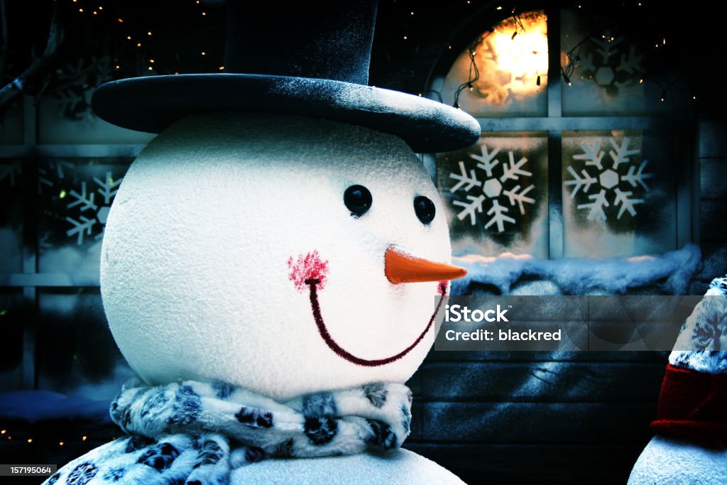 Smiling Snowman in Front of House and Frosty Window  Celebration Stock Photo