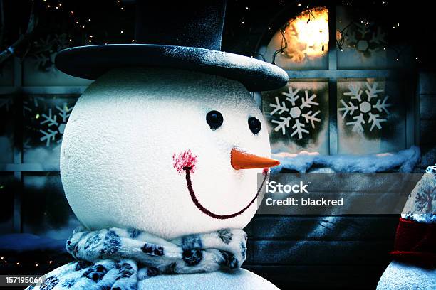 Smiling Snowman In Front Of House And Frosty Window Stock Photo - Download Image Now