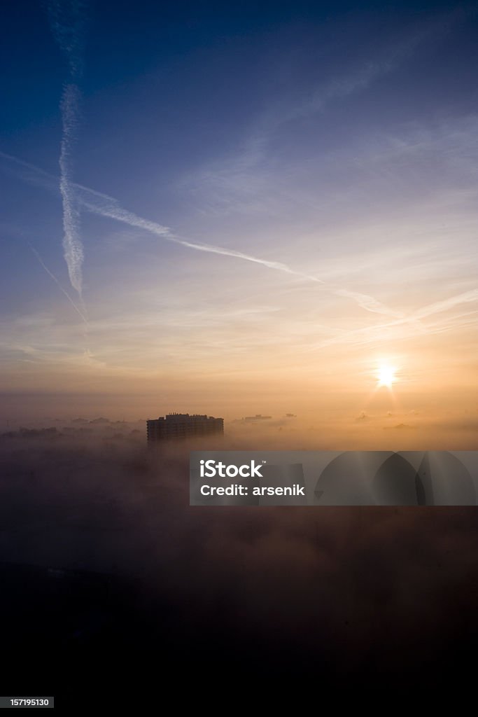 Top of the world Top of a highrise peeking through fog. Above Stock Photo