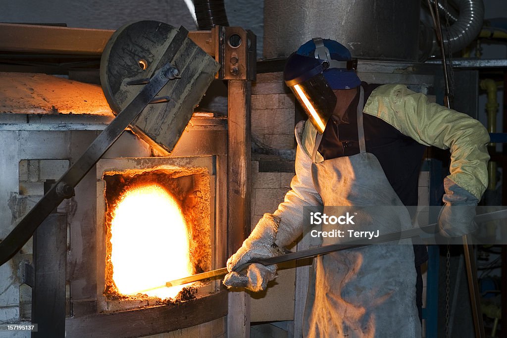 Factory Worker Close up of a factory worker dipping a ladle in molten material Blast Furnace Stock Photo