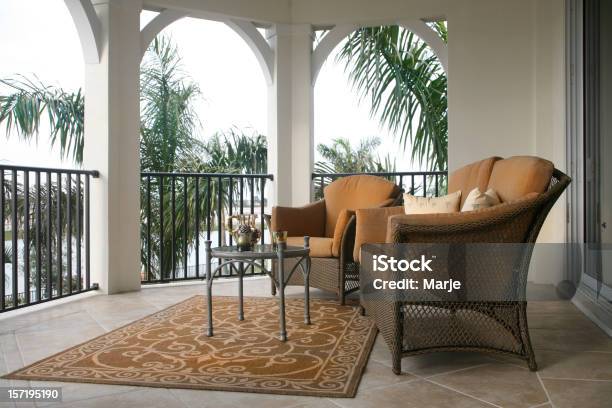 Balcony Containing 2 Chairs And Table With Palm Trees Stock Photo - Download Image Now