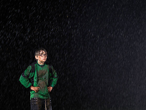 Soccer goalkeeper in the rain Young soccer goalkeeper stands in the rain teen goalie stock pictures, royalty-free photos & images