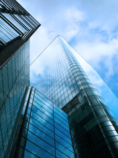 istock Contemporary glass skyscraper reflecting a blue overcast sky 157195448