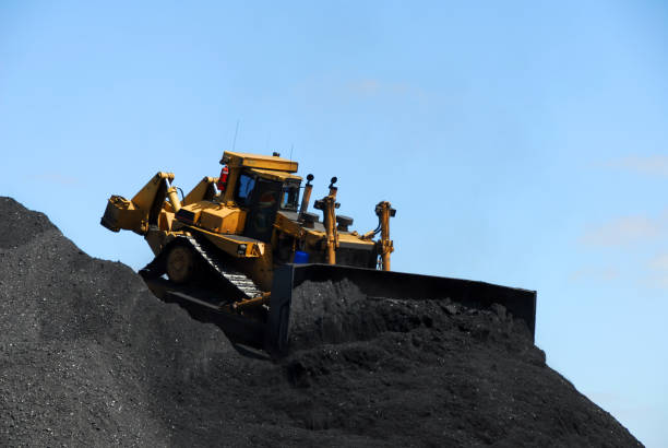 istock Bulldozing a mountain of coal 157195461