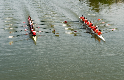 Eight oar rowing crews in a close race. 