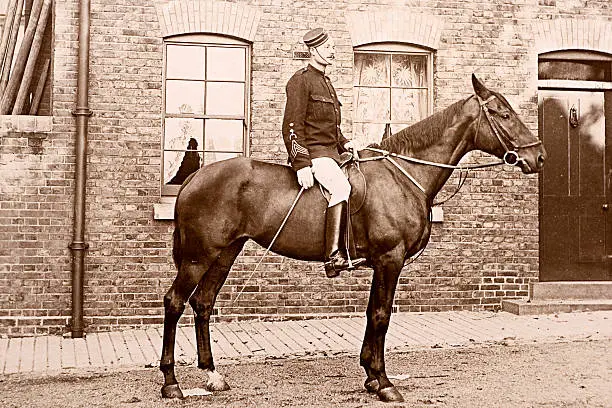 Vintage photograph of a Victorian British soldier and his horse.