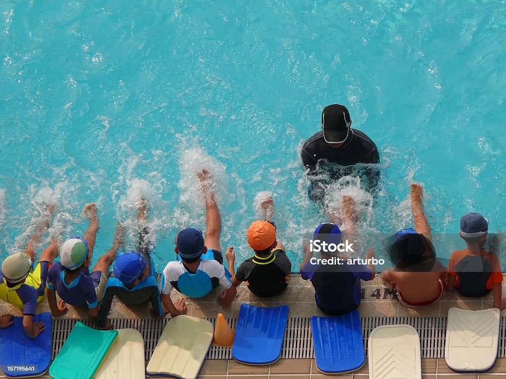 swimming class seen in a public pool in Singapore. Swimming Stock Photo