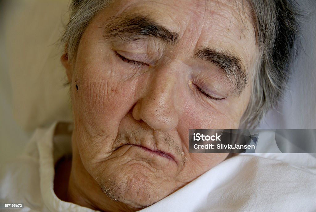 tired close-up portrait of a senior woman, sleeping in a hospital bed Bed - Furniture Stock Photo