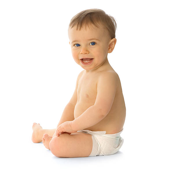 Small smiling baby sitting in nappy isolated on white stock photo