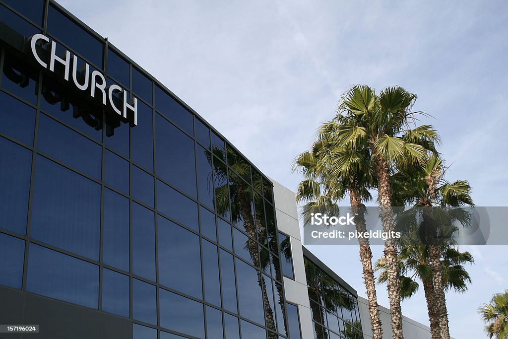 The outside of a modem church building and palm trees A modern, almost businesslike church building. Church Stock Photo