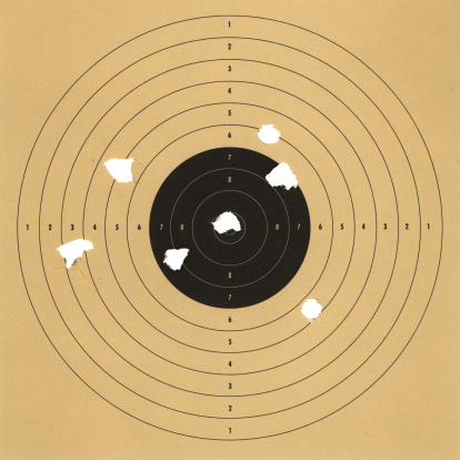 an old paper target with bullet holes