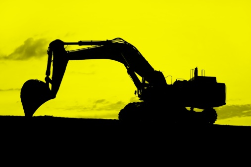 black and yellow silhouette of a digger in sunset, working late (high resolution)