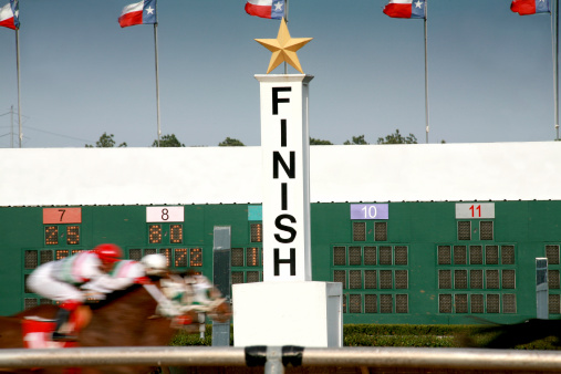 Horses coming in to the finish line at a race track.  MORE LIKE THIS...in lightboxes below.