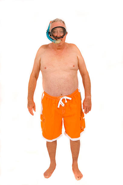 retired guy goes snorkeling stock photo
