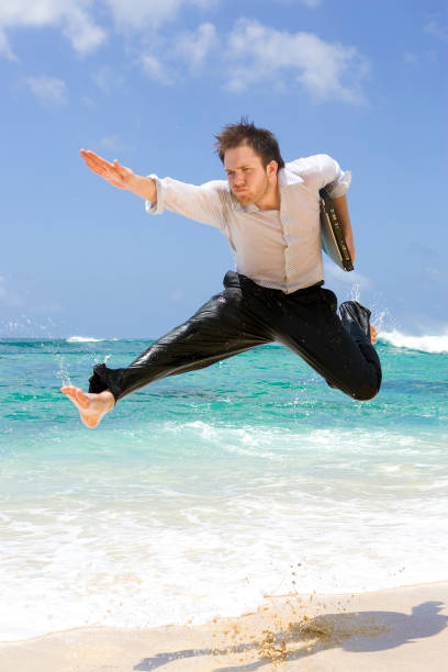 Superhero to the Rescue Superhero to the Rescue. A businessman with a laptop under his arm, springs into action, going above and beyond the call of duty. What ever it takes! soaked suit stock pictures, royalty-free photos & images