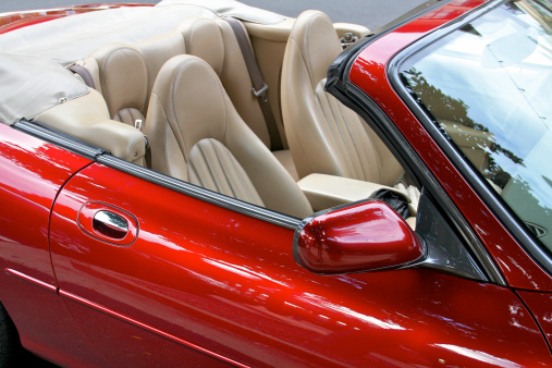 Famously rich sports convertible showing off her leather seats in public