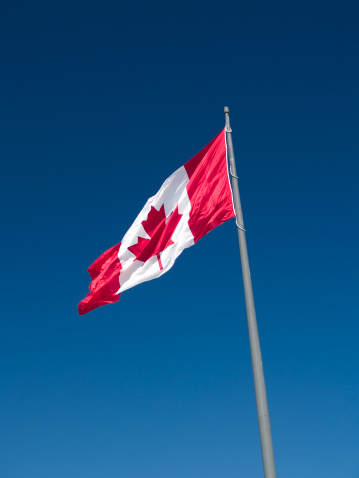Large Canadian Flag With Blue Background. Copy Space