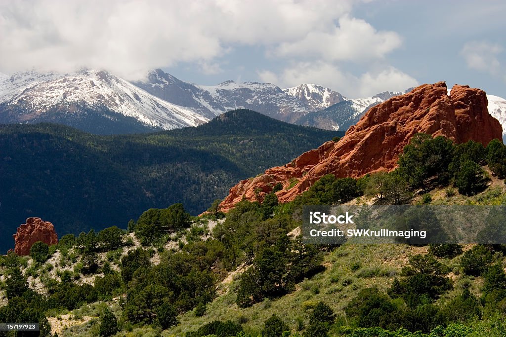 Pikes Peak & Garden of the Gods Red spires of the Garden of the Gods Park in Colorado Springs Colorado with clouds and haze moving in over Pikes Peak in the background. Colorado Springs Stock Photo