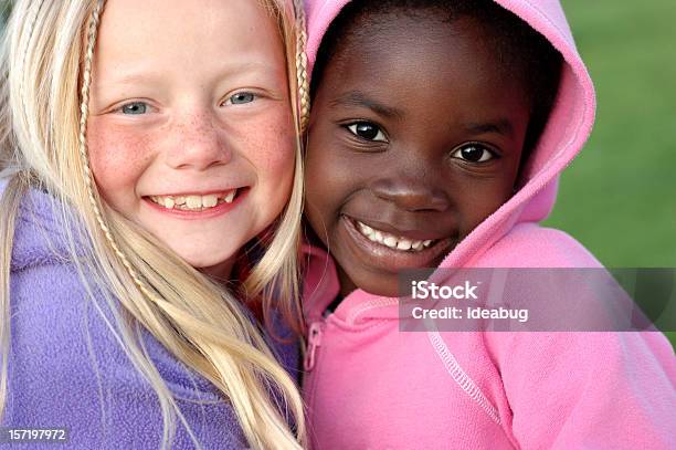 Two Happy Girls Smiling Together Outside Stock Photo - Download Image Now - Child, Friendship, Girls