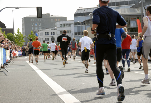 runners at the ruhr marathon, supported by spectators, applauding