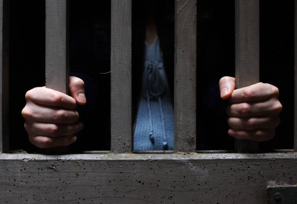 hopeless man hands tied together with rope, human trafficking