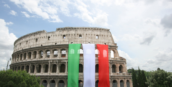 Elevated View of Rome City with various Basilica and Italian Flag flyingFlying in the wind