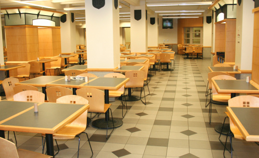 A modern cafeteria waits for people to arrive.