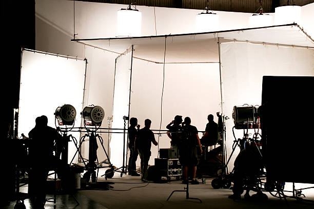 Television comercial production set. Silhouette of a production in progress on a white stage. film industry stock pictures, royalty-free photos & images
