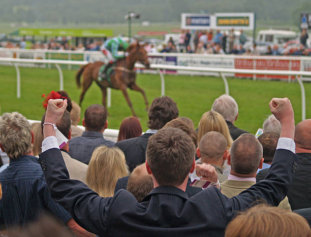 Winner A man celebrates a win at the horse races. punting stock pictures, royalty-free photos & images