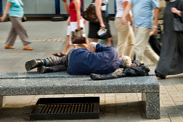 Old homeless man Old homeless man sleeping on the bench homeless person stock pictures, royalty-free photos & images