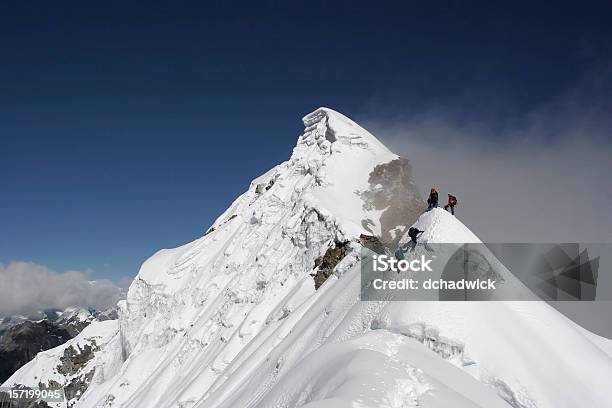 Two Climbers Almost At The Top Of A Snowy Mountain Top Stock Photo - Download Image Now