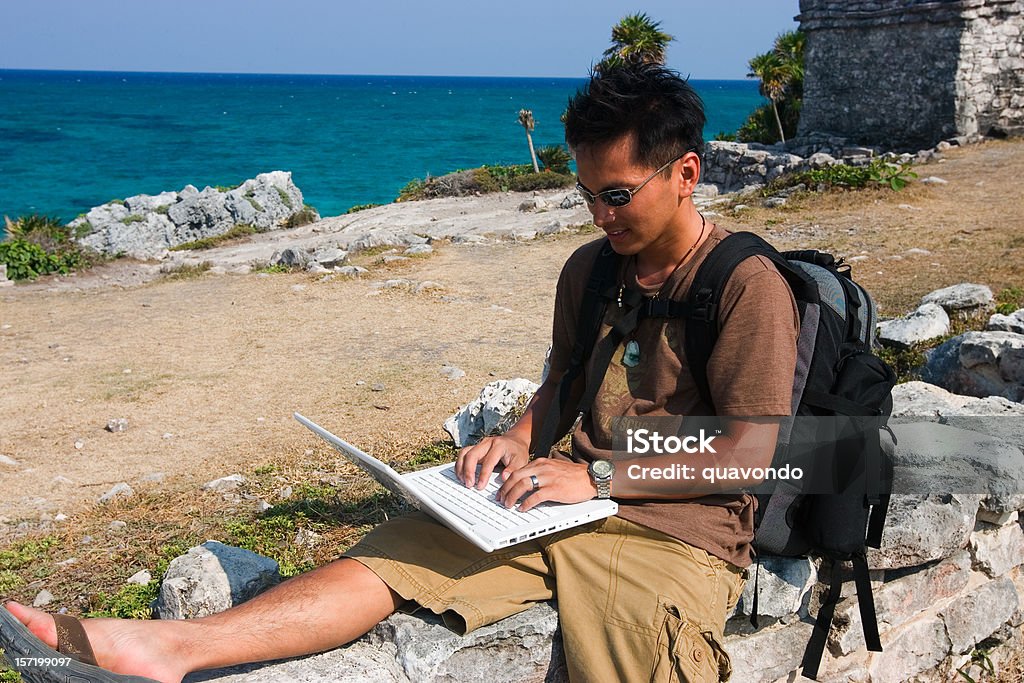 Asiatica giovane uomo escursioni in Messico utilizzando computer portatile, spazio di copia - Foto stock royalty-free di Computer portatile