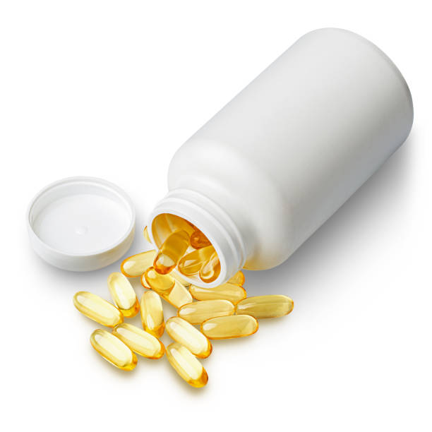 istock Omega-3 fish oil capsules scattered from bottle 1572004270