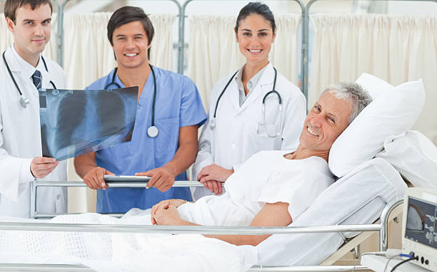 istock Doctors looking ahead and smiling next to a patient 157200537