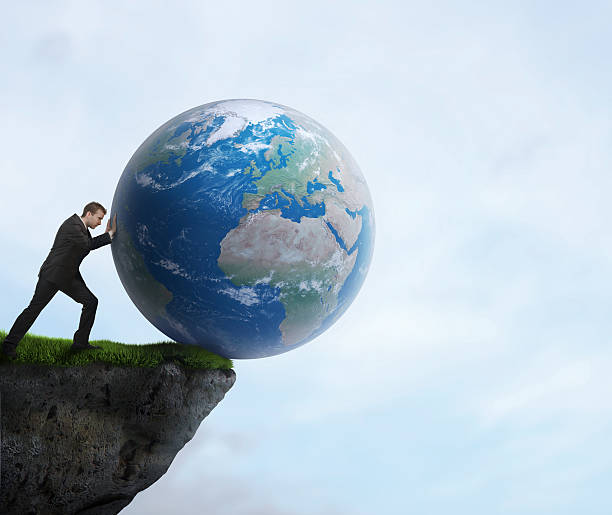 istock Businessman pushing planet Earth off a cliff 157200719