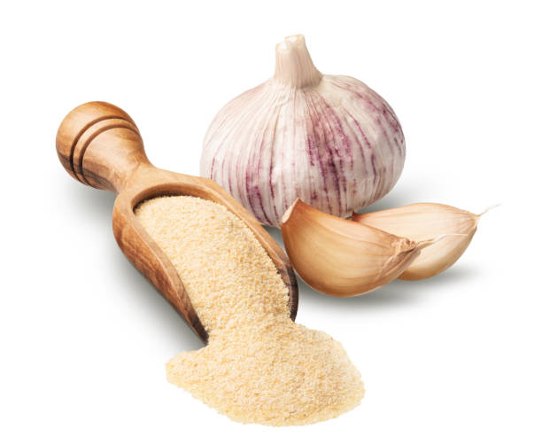 istock Fresh garlic with dried flakes isolated on white 1572008175