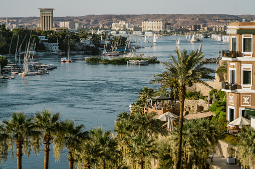 Panoramic landscape view across nile river to luxor west bank with mountains and reflection in water