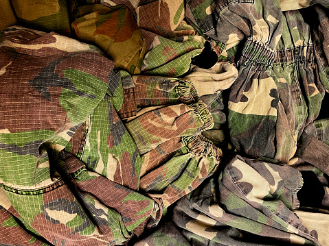 Pile of camouflage jackets in a charity shop