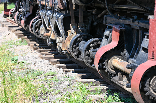 Closeup of an antique train's wheels on track