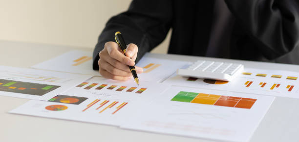 istock Businesswoman working analyzing business growth charts in documents, financial reports and investment planning analysis. Finance, Budget Management and Accounting 1572036882