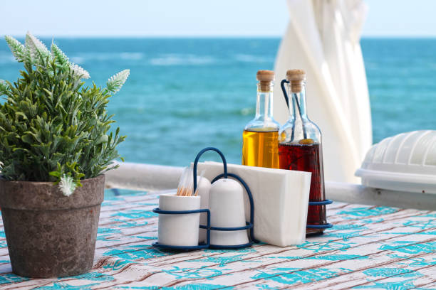 View of a table in open-air restaurant overlooking the sea.