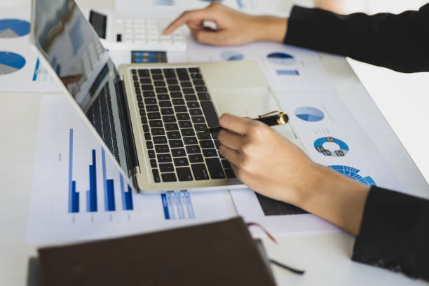 istock Businesswoman working with laptop and documents analyzing business charts and planning investment strategy. 1572037413