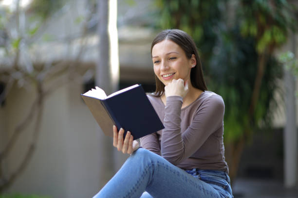 istock Female university students reading textbooks preparing for exams. 1572039879