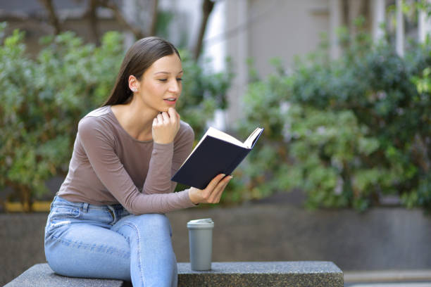 istock Female university students reading textbooks preparing for exams. 1572040169