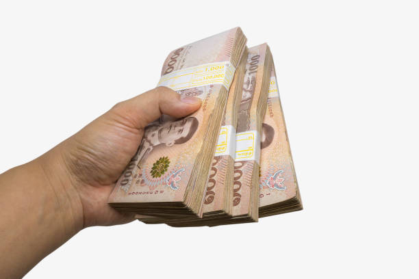 istock hand hold THB cash bundles, money stacks 1572040178